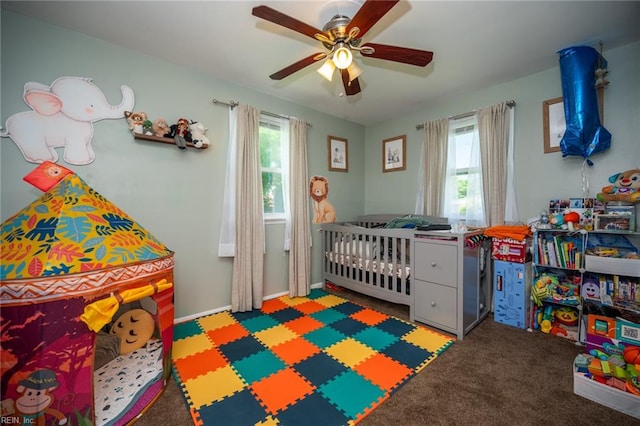 bedroom featuring ceiling fan, carpet, and a nursery area