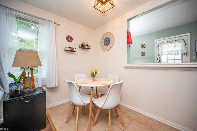 tiled dining area with a healthy amount of sunlight