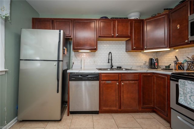 kitchen featuring backsplash, light tile patterned flooring, sink, and stainless steel appliances