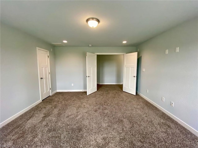 unfurnished bedroom with dark colored carpet