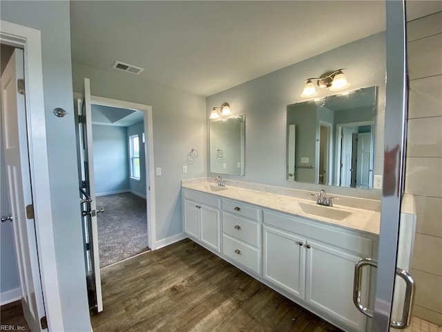 bathroom with hardwood / wood-style flooring and vanity