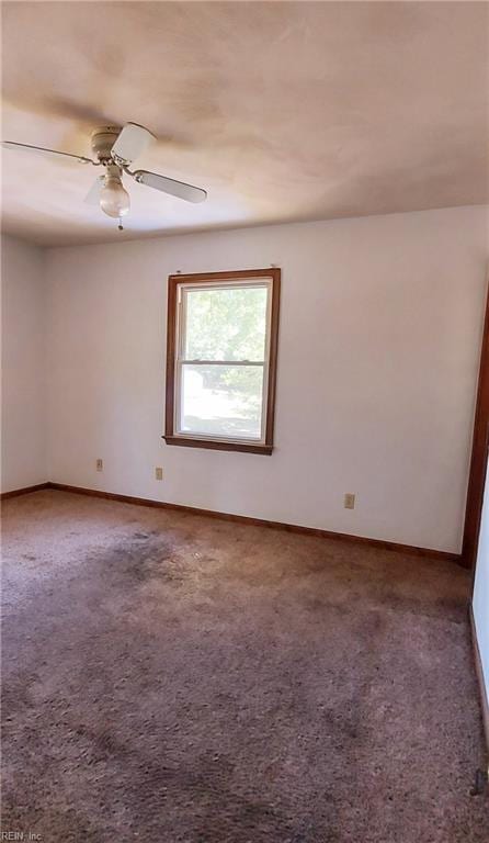 spare room featuring carpet flooring and ceiling fan