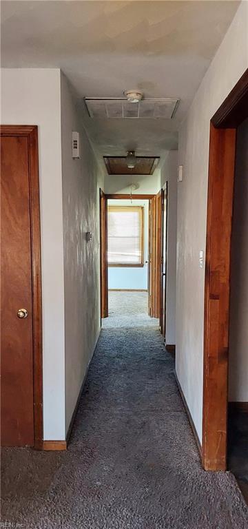 corridor with dark colored carpet