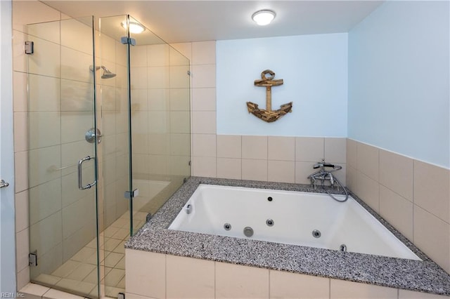 bathroom featuring separate shower and tub