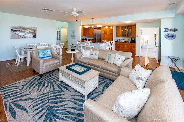 living room featuring ceiling fan and wood-type flooring