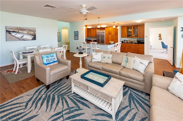 living room with dark hardwood / wood-style floors and ceiling fan