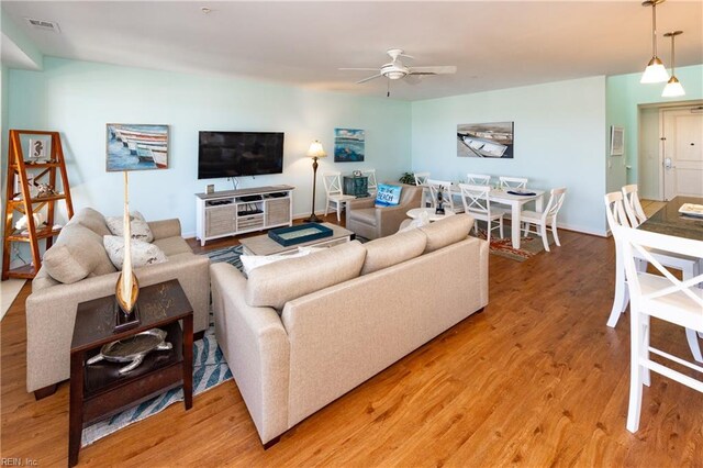 living room featuring ceiling fan and light hardwood / wood-style floors