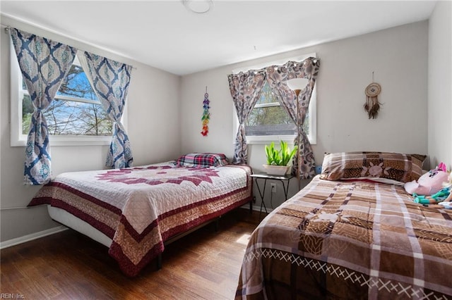 bedroom featuring multiple windows and hardwood / wood-style floors