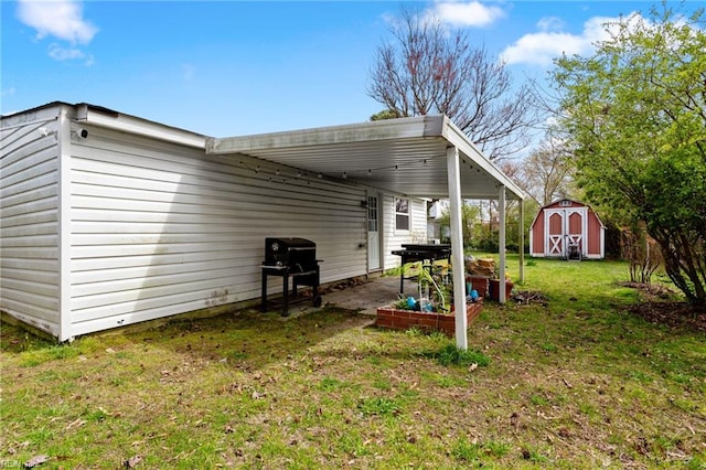 exterior space with a lawn, a patio area, and a storage unit