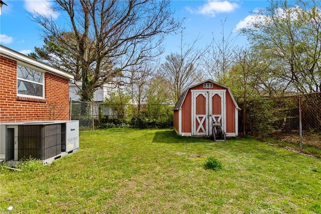 view of yard with central air condition unit and a shed