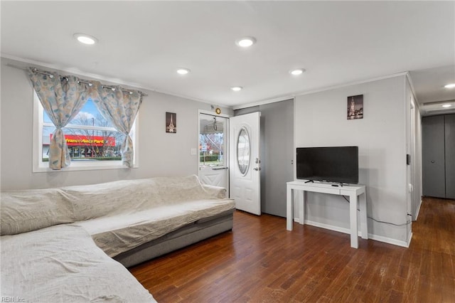 living room with ornamental molding and dark wood-type flooring