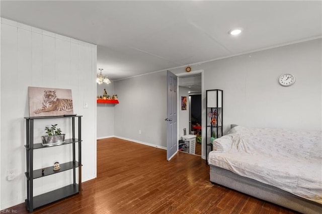 bedroom with ornamental molding, dark wood-type flooring, and a notable chandelier