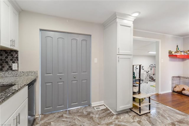 kitchen with light stone countertops, stainless steel dishwasher, ornamental molding, light hardwood / wood-style flooring, and white cabinetry