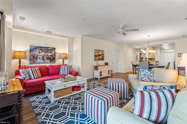 living room featuring ceiling fan with notable chandelier