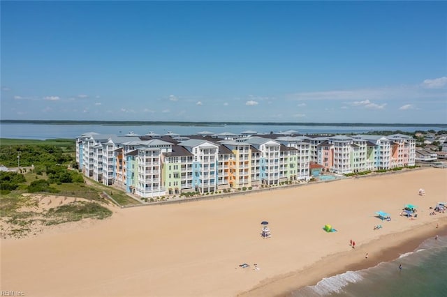 bird's eye view with a water view and a beach view