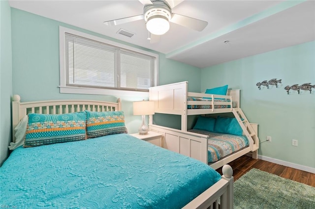 bedroom with ceiling fan and dark hardwood / wood-style floors