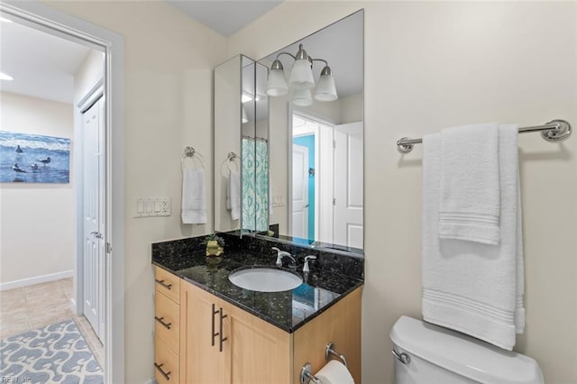 bathroom featuring tile patterned flooring, vanity, and toilet