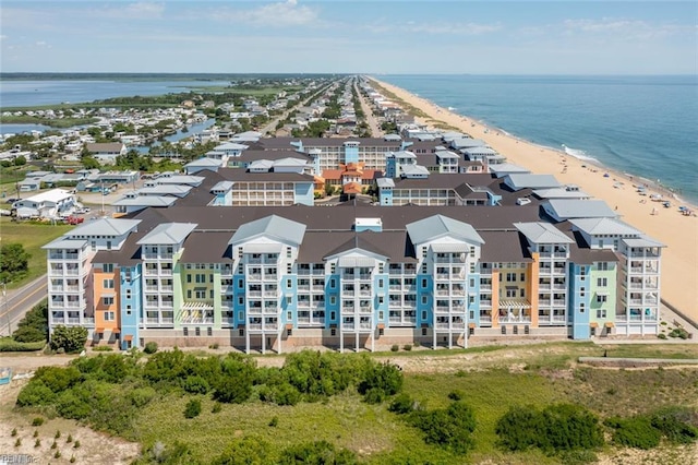 drone / aerial view with a water view and a beach view