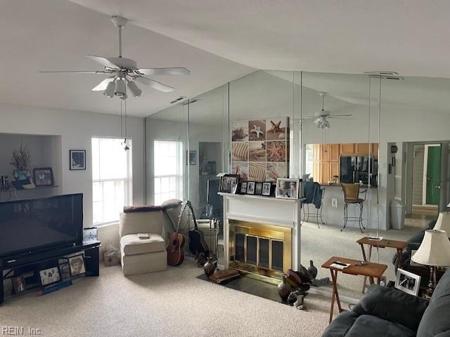 living room with high vaulted ceiling, ceiling fan, and carpet floors