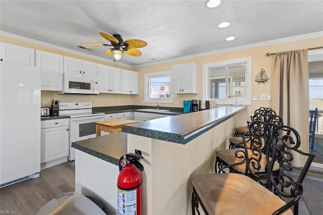 kitchen with white cabinets, ceiling fan, white appliances, and crown molding