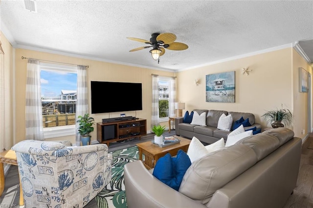 living room with a textured ceiling, hardwood / wood-style flooring, ceiling fan, and crown molding