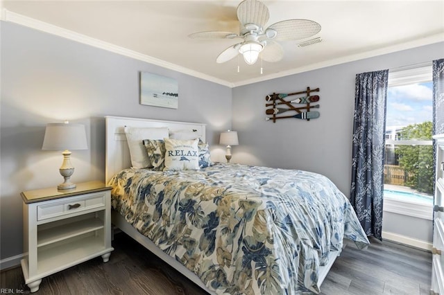 bedroom featuring dark hardwood / wood-style flooring, ceiling fan, and ornamental molding