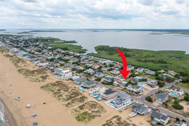 aerial view featuring a view of the beach and a water view