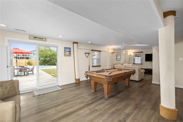 game room with a textured ceiling, dark hardwood / wood-style floors, a wealth of natural light, and billiards