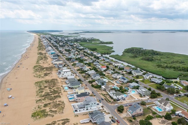 birds eye view of property with a water view and a view of the beach