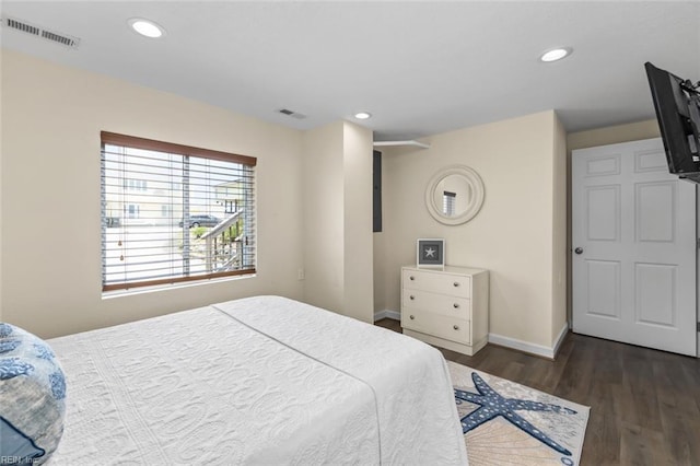 bedroom with dark hardwood / wood-style flooring