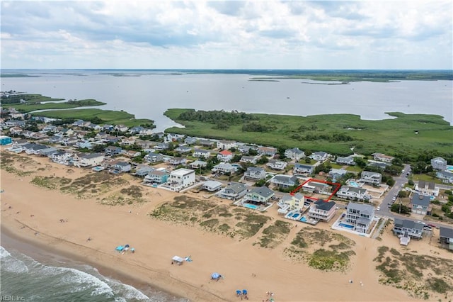 aerial view with a water view and a view of the beach