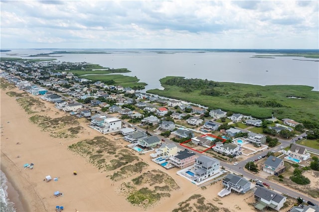 aerial view with a water view and a view of the beach