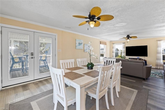 dining area featuring french doors, a textured ceiling, ornamental molding, and hardwood / wood-style floors