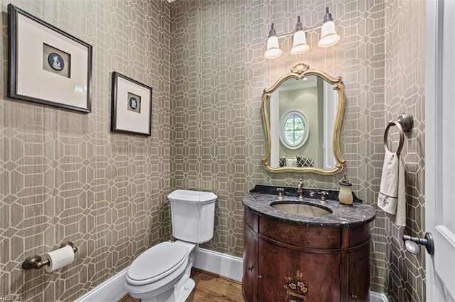 bathroom featuring vanity, hardwood / wood-style flooring, and toilet