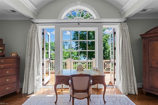 interior space featuring hardwood / wood-style floors, lofted ceiling, and ornamental molding