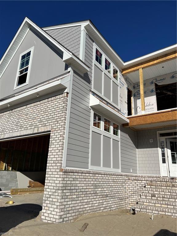 view of home's exterior with a garage and brick siding