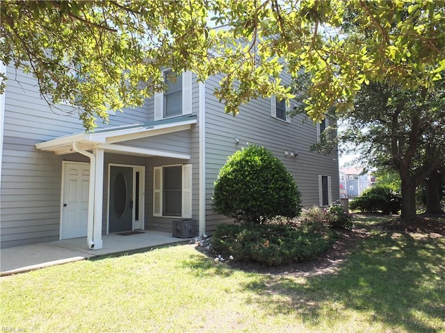 rear view of property with a lawn