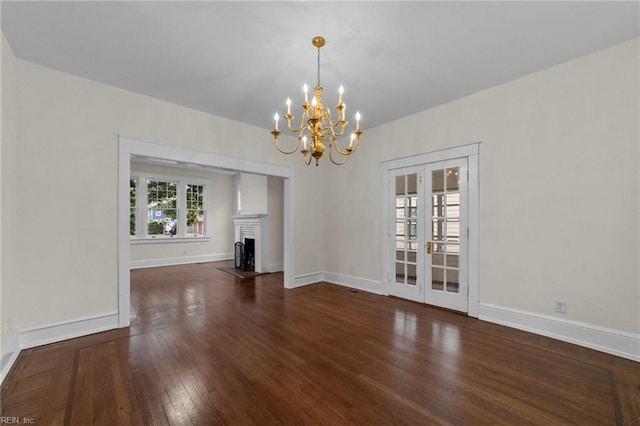 interior space featuring a notable chandelier, french doors, and dark hardwood / wood-style flooring