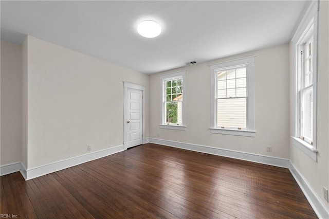 empty room with dark hardwood / wood-style floors