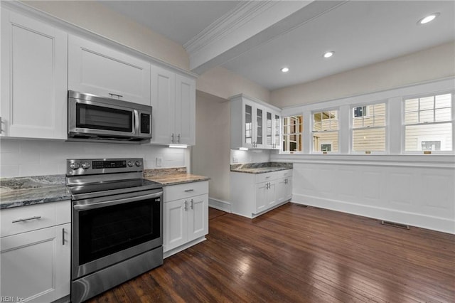 kitchen featuring stainless steel appliances, dark hardwood / wood-style flooring, light stone counters, backsplash, and white cabinetry