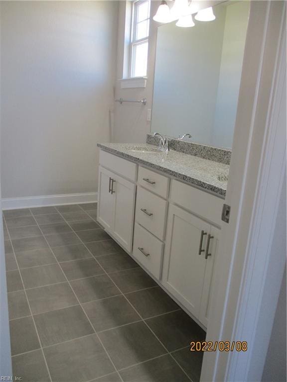 bathroom featuring vanity, a notable chandelier, and tile patterned flooring