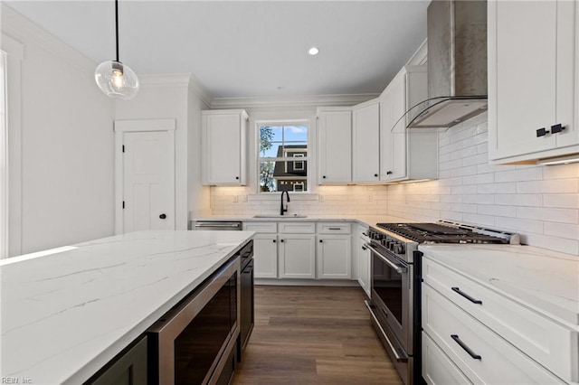 kitchen featuring stainless steel range, built in microwave, wall chimney range hood, and white cabinetry