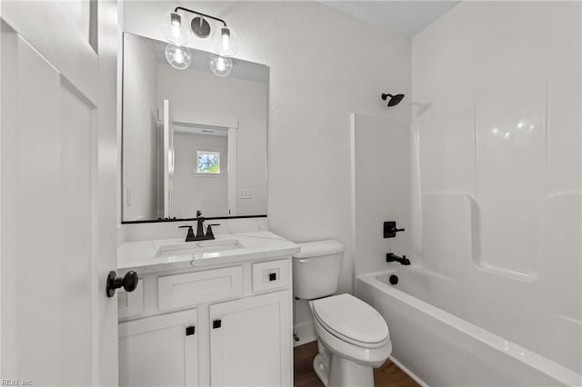 full bathroom with hardwood / wood-style floors, toilet, vanity, and  shower combination