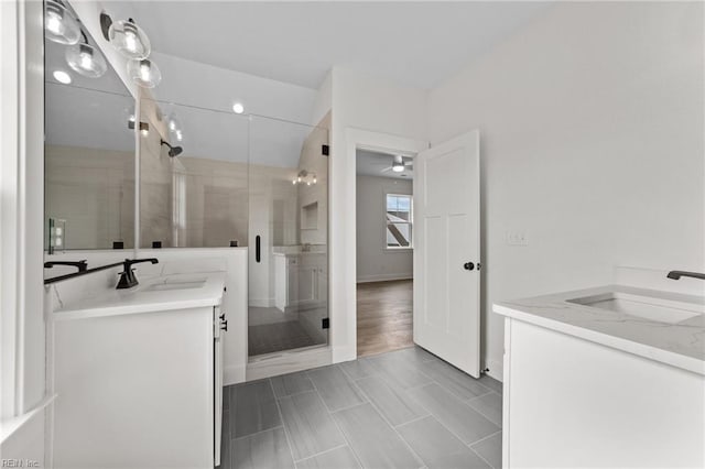 bathroom with vanity and a shower with door