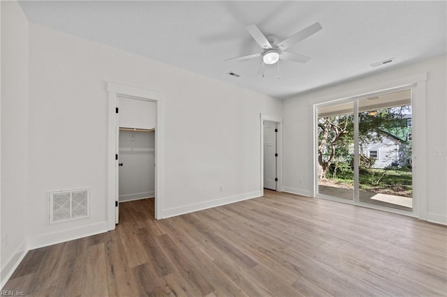 empty room featuring ceiling fan and hardwood / wood-style floors