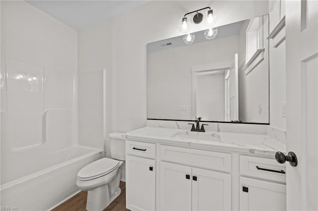 full bathroom with wood-type flooring, toilet, vanity, and  shower combination