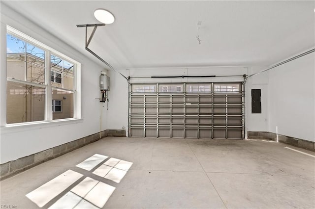 garage featuring water heater and electric panel