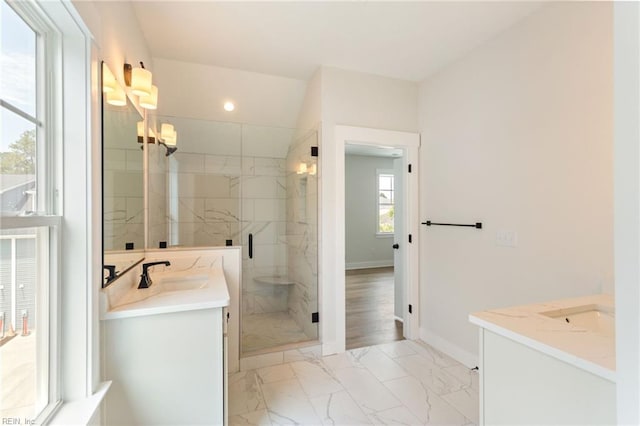 bathroom featuring walk in shower and vanity