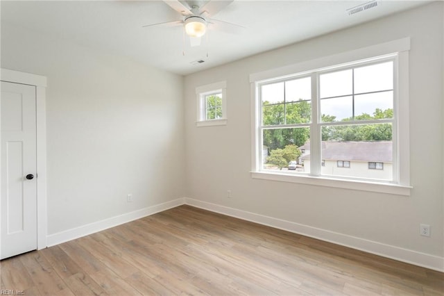 empty room featuring ceiling fan and light hardwood / wood-style flooring