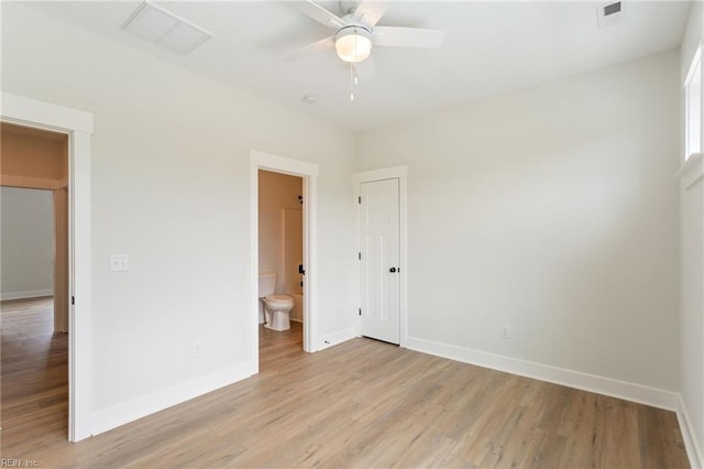 unfurnished bedroom with ceiling fan, connected bathroom, and light wood-type flooring